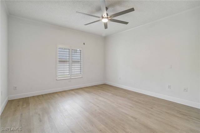 empty room featuring ceiling fan, light hardwood / wood-style floors, and a textured ceiling