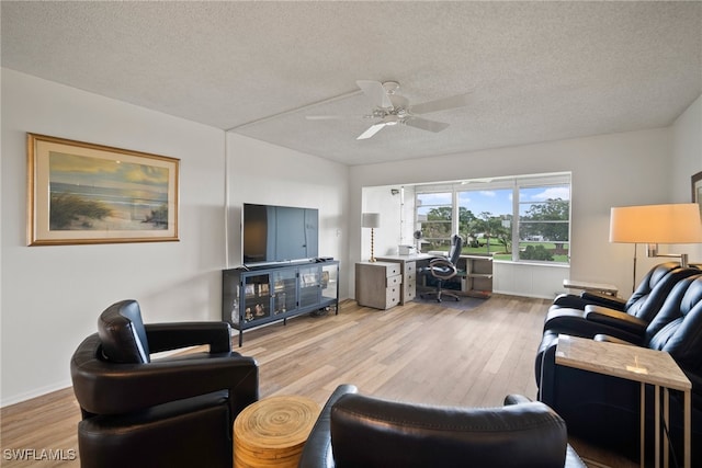 living room featuring a textured ceiling, hardwood / wood-style flooring, and ceiling fan