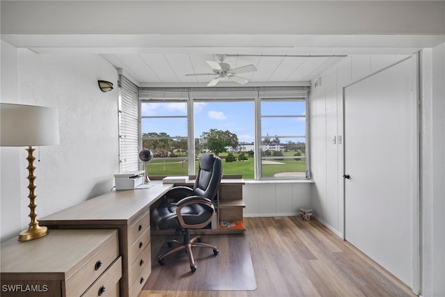 office space with light hardwood / wood-style flooring, ceiling fan, and beam ceiling