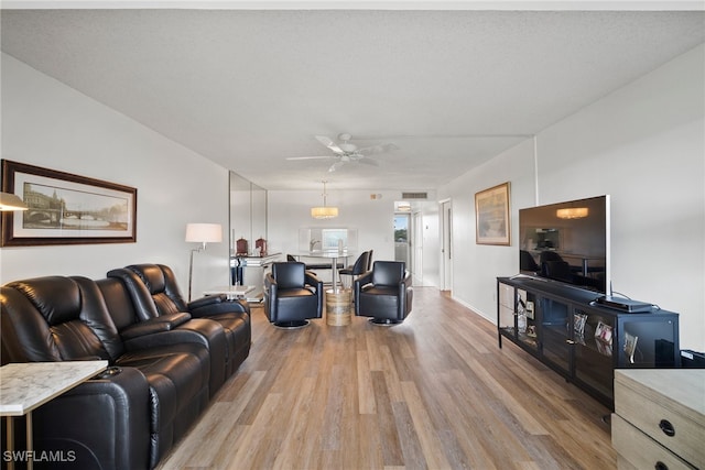 living room featuring light hardwood / wood-style floors and ceiling fan