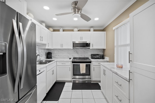 kitchen with white cabinets, crown molding, sink, and appliances with stainless steel finishes