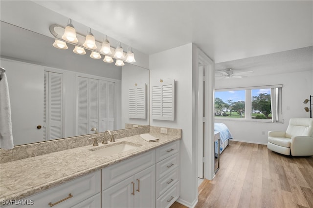 bathroom with vanity, hardwood / wood-style floors, and ceiling fan