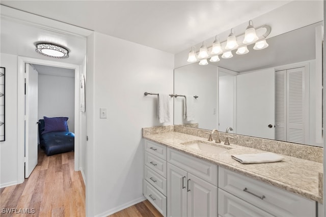 bathroom featuring wood-type flooring and vanity