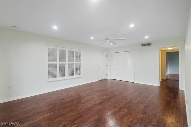 empty room with ceiling fan and dark hardwood / wood-style floors