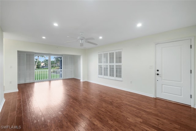 unfurnished living room with ceiling fan and dark hardwood / wood-style flooring