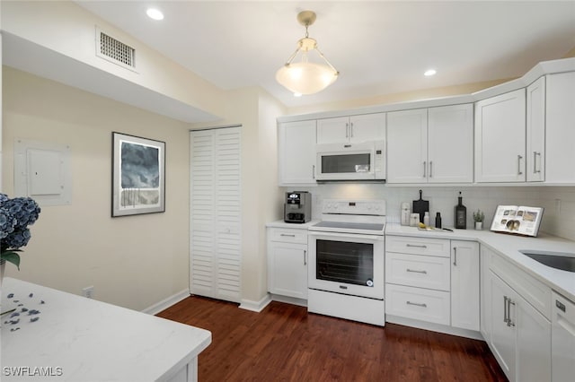 kitchen with white cabinets, decorative light fixtures, dark hardwood / wood-style floors, and white appliances