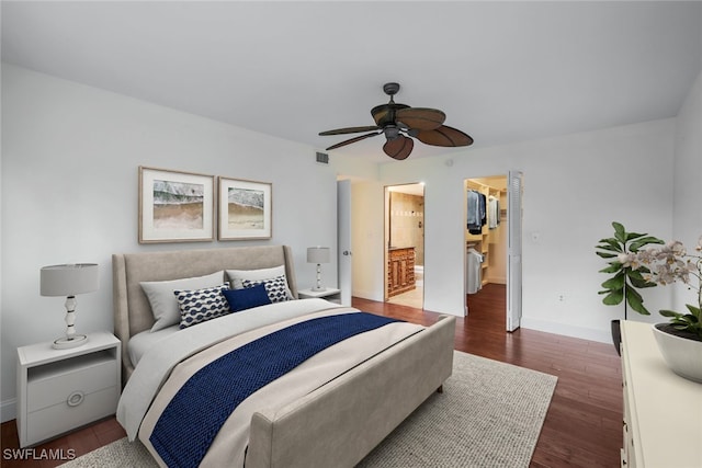 bedroom with ensuite bathroom, dark hardwood / wood-style floors, and ceiling fan