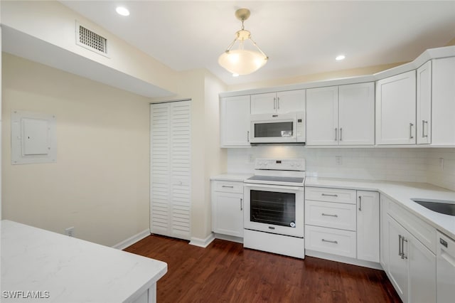 kitchen with pendant lighting, white cabinetry, dark hardwood / wood-style floors, and white appliances