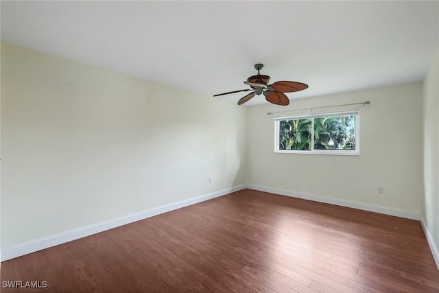 empty room featuring dark wood-type flooring and ceiling fan