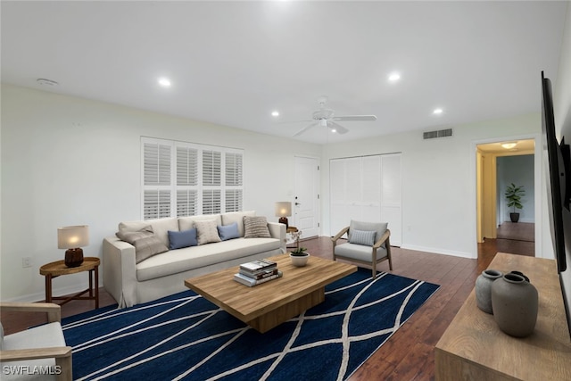 living room with dark wood-type flooring and ceiling fan