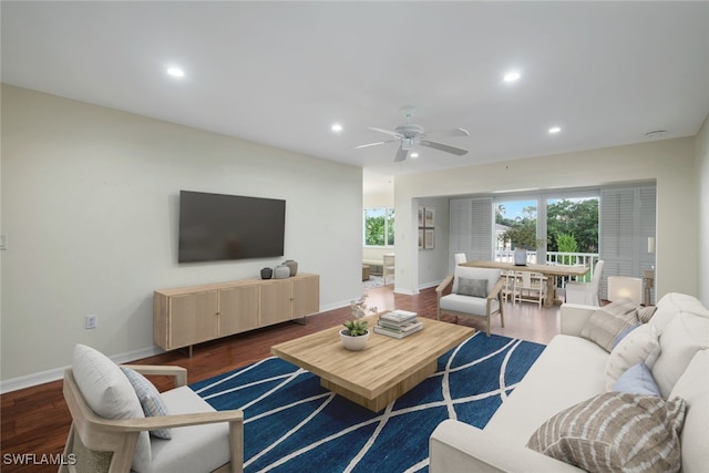 living room with dark hardwood / wood-style floors and ceiling fan