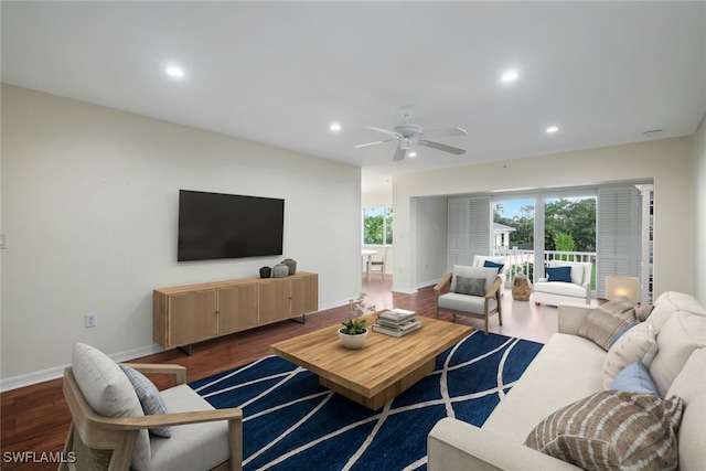 living room featuring dark hardwood / wood-style flooring and ceiling fan