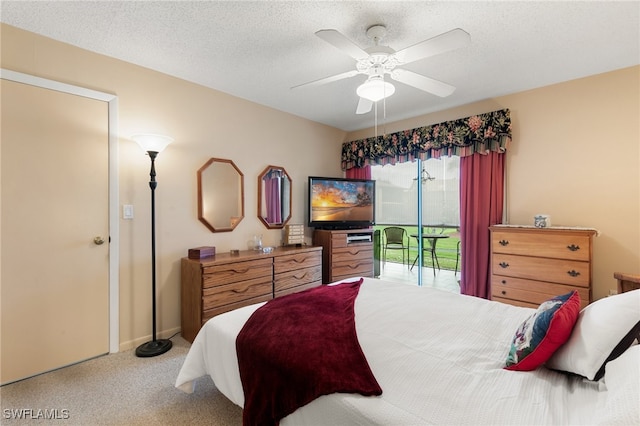 bedroom featuring access to outside, ceiling fan, carpet flooring, and a textured ceiling