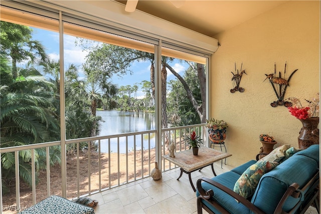 sunroom / solarium featuring a water view