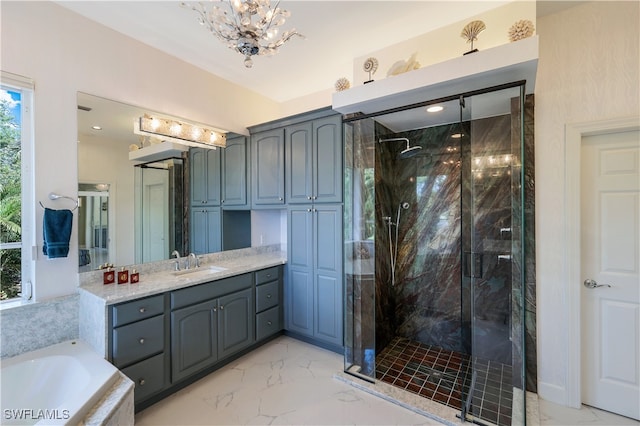 bathroom featuring shower with separate bathtub, vanity, and a notable chandelier