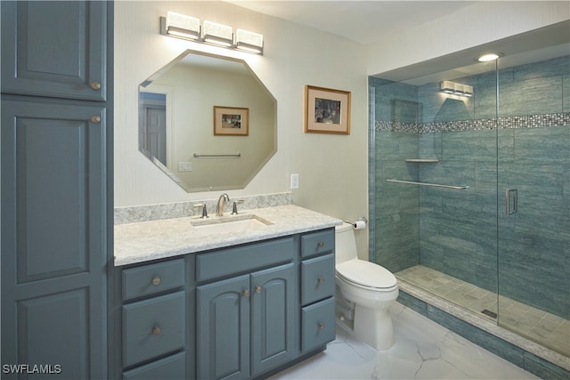 bathroom with a shower with door, vanity, and toilet