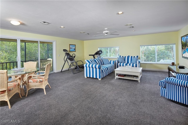 living room with ceiling fan and dark carpet