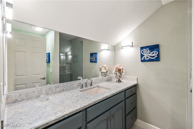 bathroom with an enclosed shower, lofted ceiling, and vanity