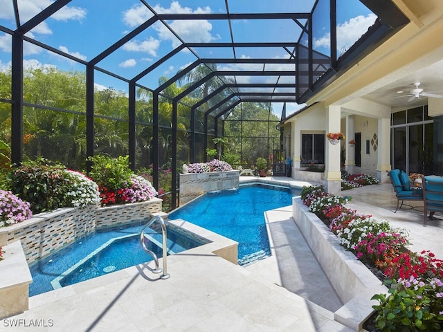 view of swimming pool with a hot tub, ceiling fan, glass enclosure, and a patio