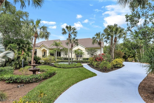 mediterranean / spanish home featuring a front lawn