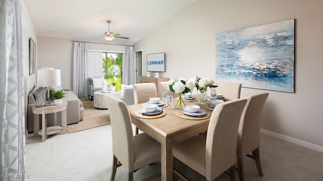 dining space with ceiling fan, light tile patterned floors, and lofted ceiling