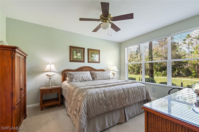 bedroom featuring ceiling fan and light colored carpet