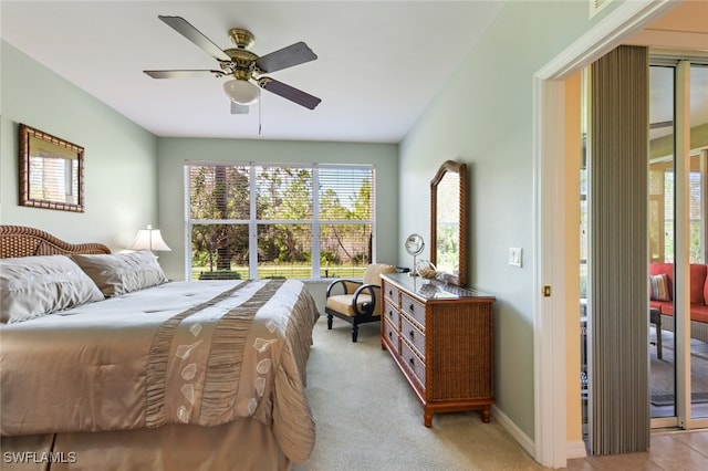 bedroom featuring access to outside, light carpet, and ceiling fan