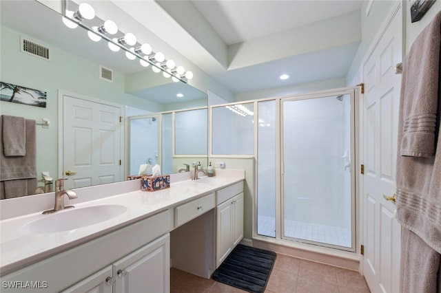 bathroom featuring vanity, walk in shower, and tile patterned flooring