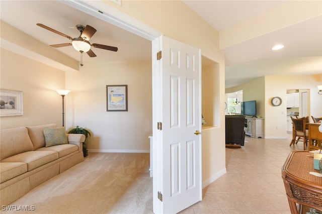 living room with light carpet and ceiling fan