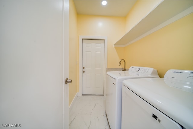 clothes washing area with washing machine and dryer