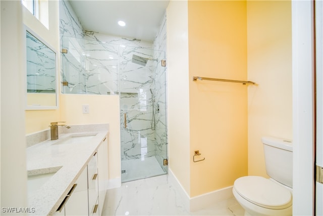 bathroom featuring vanity, toilet, and a shower with shower door