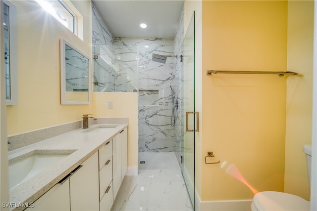 bathroom featuring a shower with shower door, vanity, and toilet