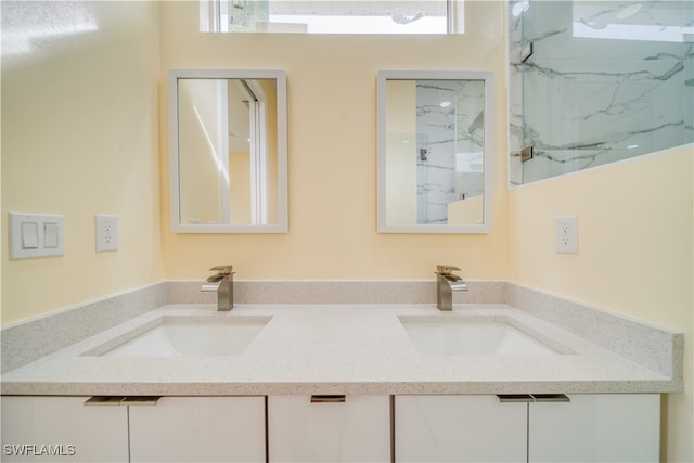 bathroom with vanity and tiled shower