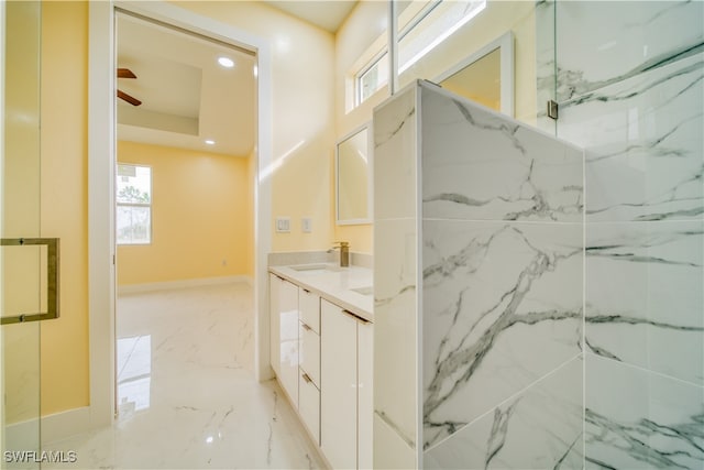 bathroom featuring ceiling fan, vanity, and a tile shower