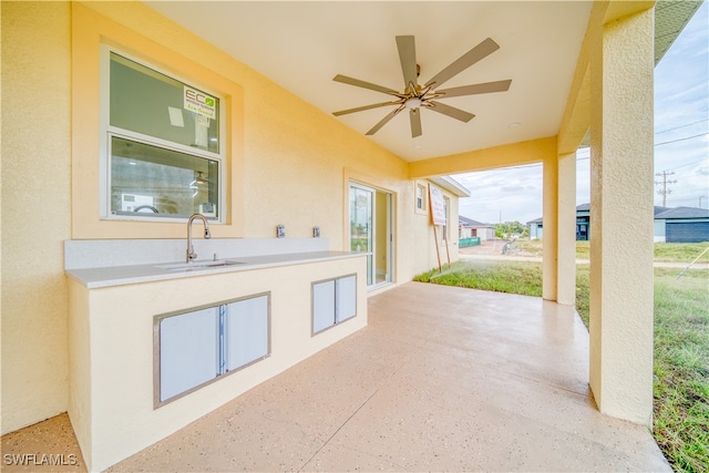 view of patio / terrace featuring sink and ceiling fan