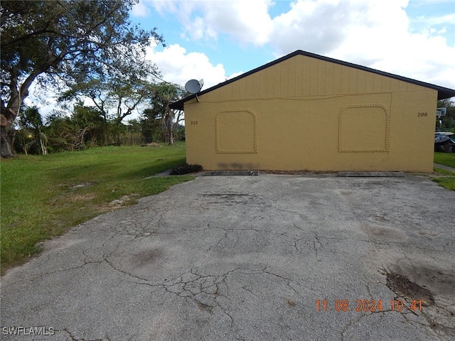 view of property exterior featuring a lawn