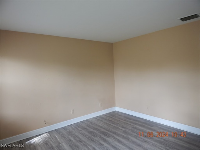 empty room featuring dark hardwood / wood-style flooring