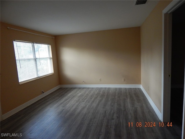 spare room featuring dark hardwood / wood-style flooring