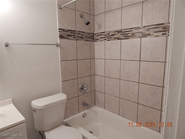 full bathroom featuring vanity, toilet, and tiled shower / bath combo