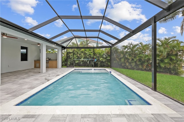 view of pool featuring a patio, a lanai, ceiling fan, and pool water feature