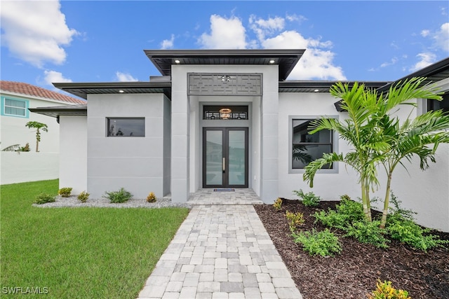 view of exterior entry with a yard