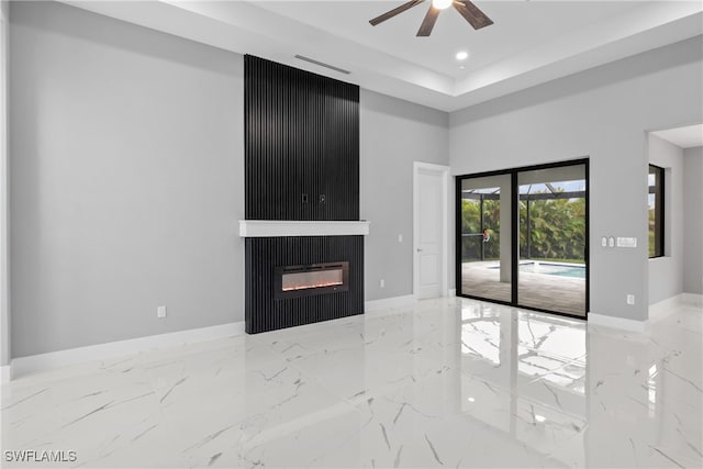 unfurnished living room featuring a fireplace and ceiling fan