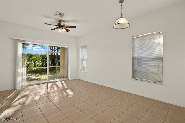 empty room with light tile patterned floors and ceiling fan