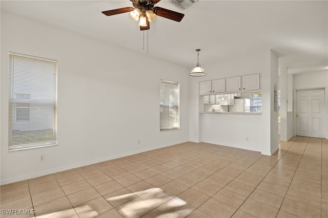 unfurnished living room with light tile patterned floors and ceiling fan