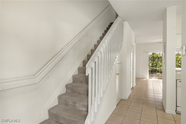 staircase with tile patterned floors