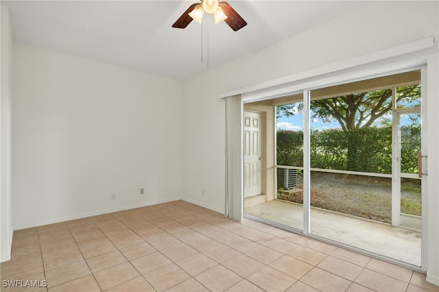 tiled spare room featuring ceiling fan