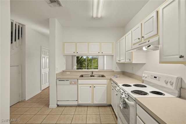 kitchen with light tile patterned flooring, white appliances, white cabinetry, and sink