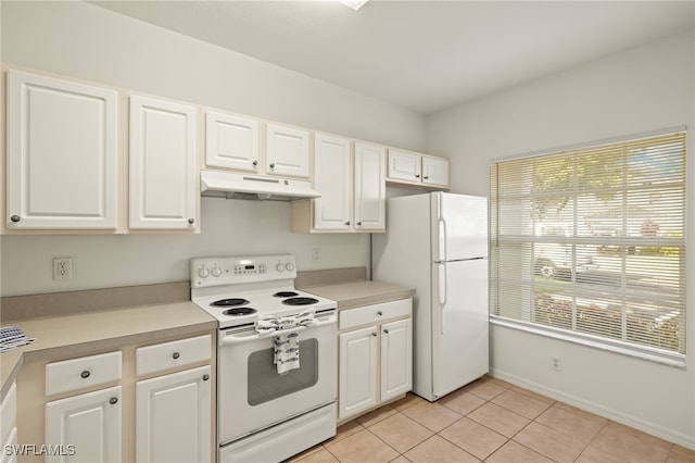 kitchen featuring light tile patterned floors, white appliances, and white cabinetry