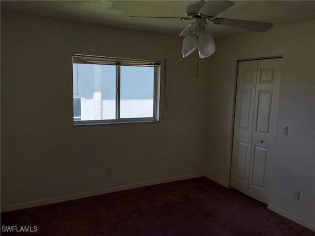 carpeted spare room with ceiling fan