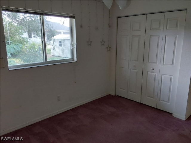 unfurnished bedroom featuring a closet and carpet